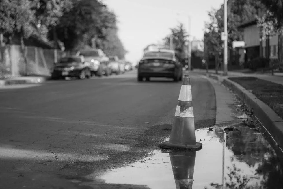 black and white street with cone