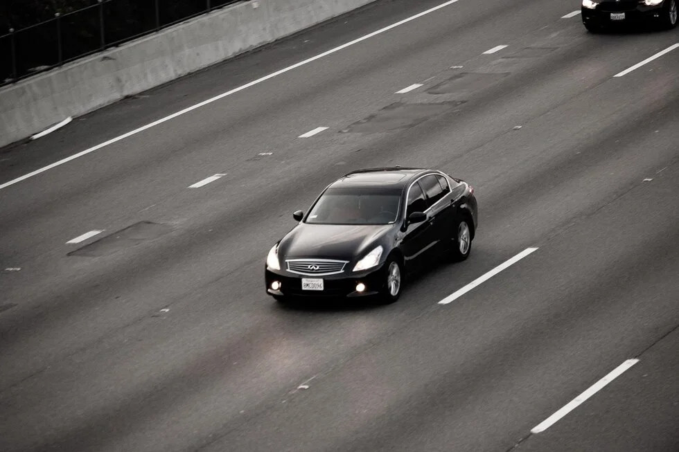 black and white car on highway