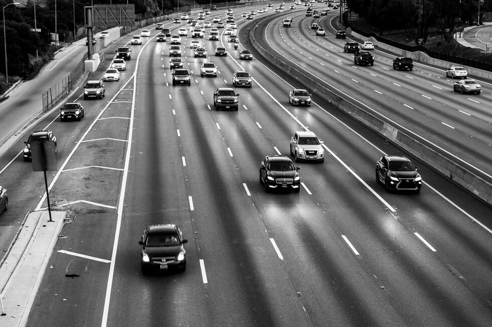cars on highway black and white