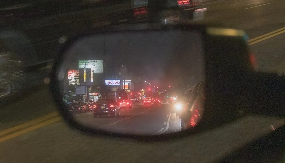 side mirror city at night