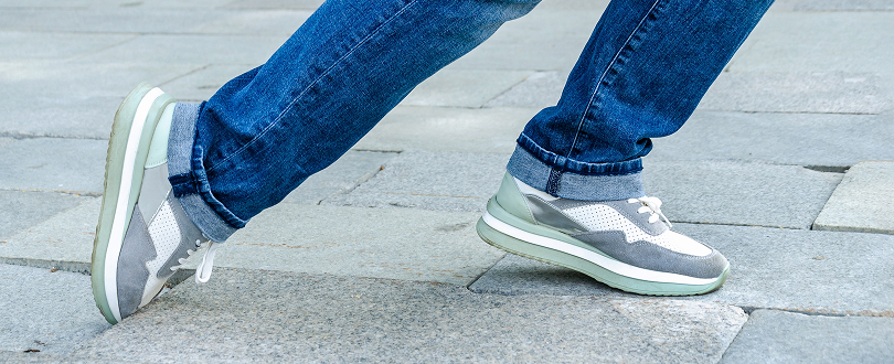 person tripping on uneven pavement