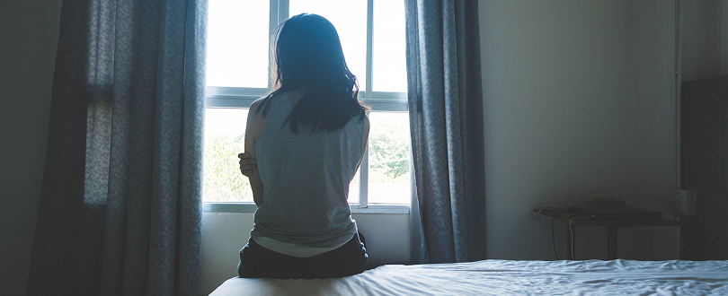 woman looking out window