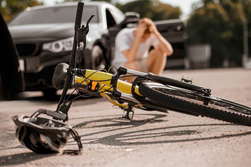 Bicycle accident scene in Meridian with injured cyclist after a car collision — used for Meridian bicycle accident lawyer page.