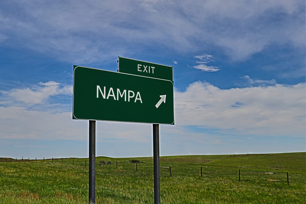 Highway exit sign for Nampa, Idaho, representing travel routes and dangerous roads highlighted in Nampa car accident safety guide.