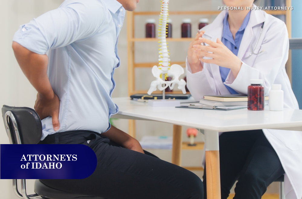 doctor examining patient with back pain after spinal cord injuries from rear-end crashes