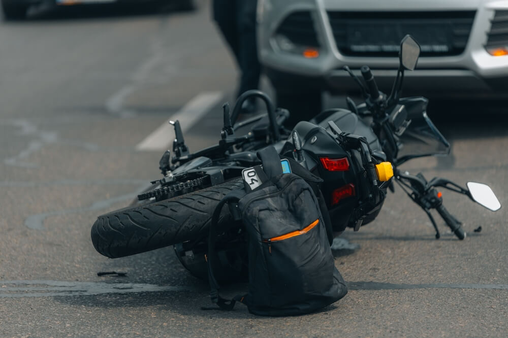 Damaged motorcycle at crash scene, motorcycle accident attorney in Boise